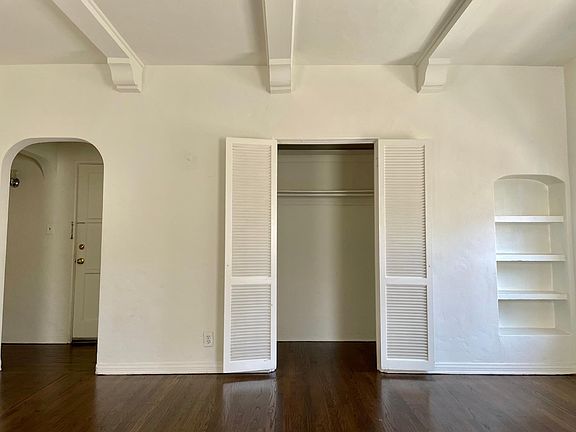 Very spacious living room with chic built in bookshelf.