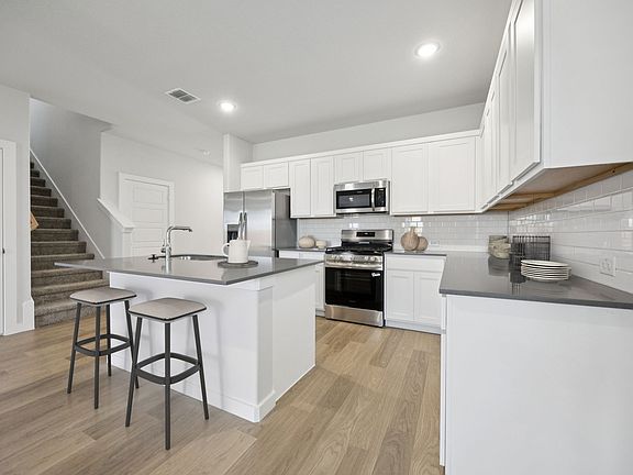 Kitchen in the Haylee home plan by Trophy Signature Homes - REPRESENTATIVE PHOTO
