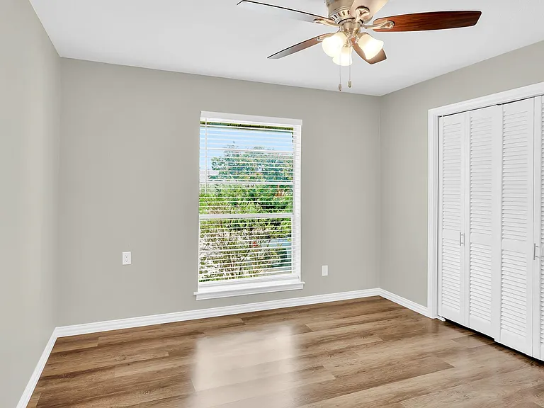 Guest bedroom with large window.