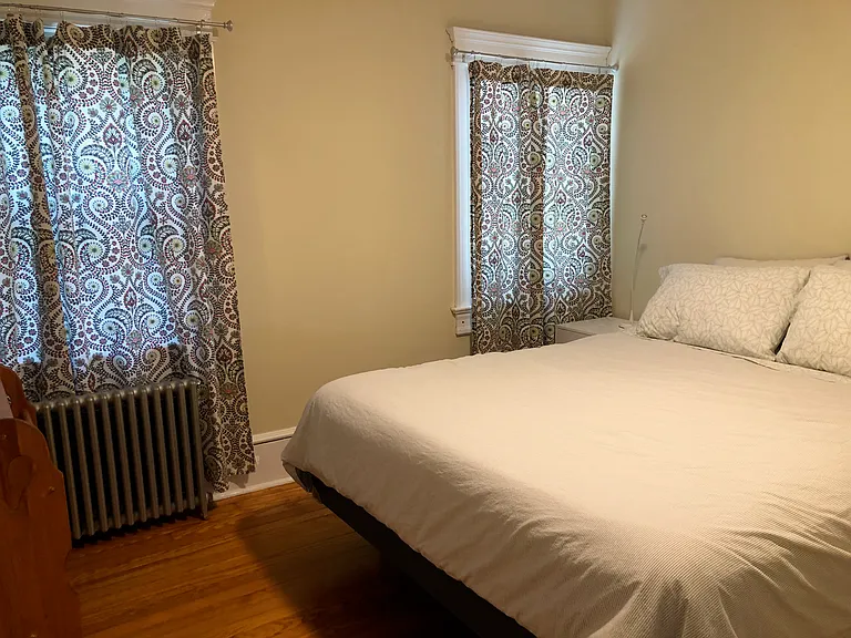 East-facing middle bedroom has queen size bed, 2 bedside tables, large dresser, ceiling fan, closet, 40" smart TV