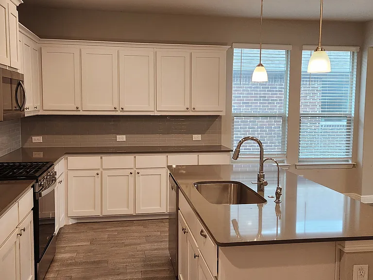 additional seating at island, pendant lights, recessed can lights