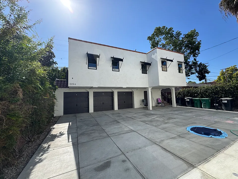 Rear courtyard, parking for 2 cars, with one car garage available, EV charging on-site