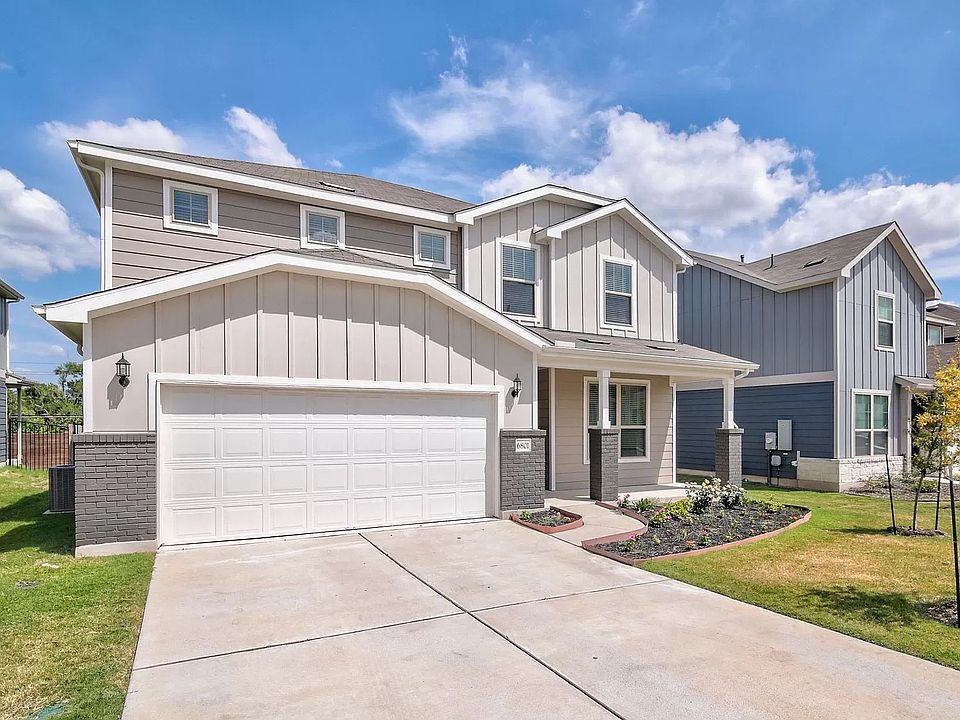 Beautiful front of home with 2 car garage, long driveway, and front porch