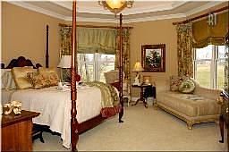 Master suite with trey ceiling offering trey ceilings and heavy crown molding