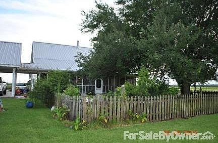 Back of home
						:
						Part of back yard fenced with bricked area--perfect for small children or pets