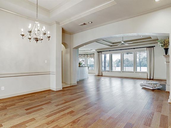 Notice the attention to details in the crown molding, chair-rail, arches, and step up ceilings.