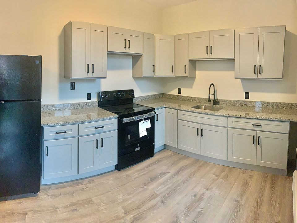 Kitchen: granite countertops with new fridge and electric stove.