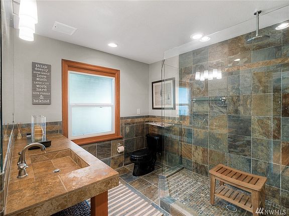 Gorgeous 3/4 bath features slate floors and large shower with slate surround and rain shower head.