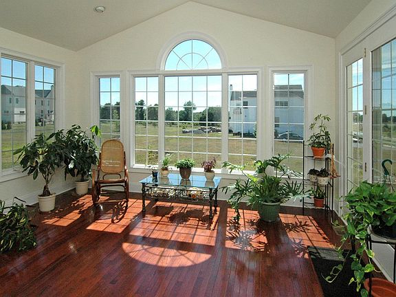 Sunroom surrounded by window that captures the open views.