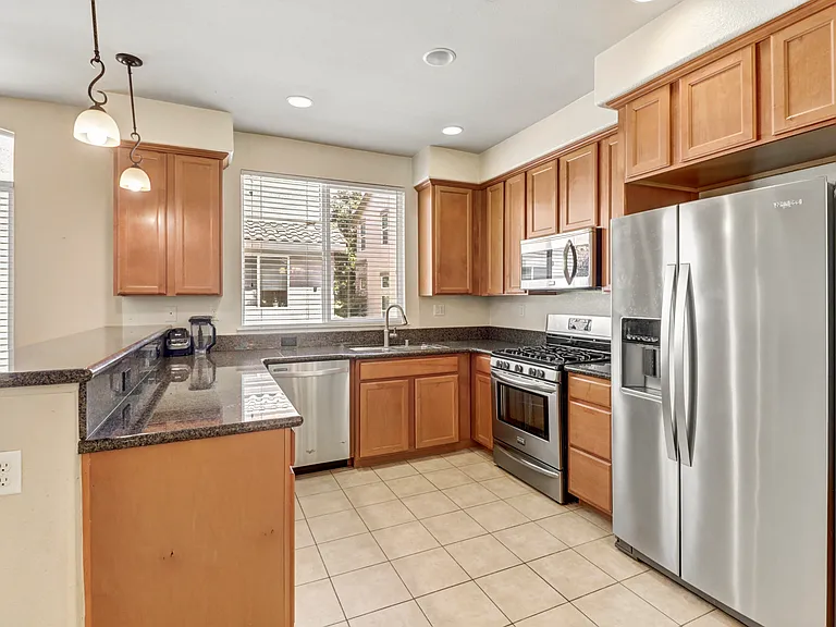 Kitchen with Whirlpool Dishwasher and Whirlpool side by side Refrigerator with Ice/Filtered water dispenser on door