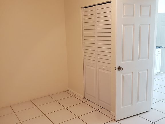 Bedroom with fan and closet