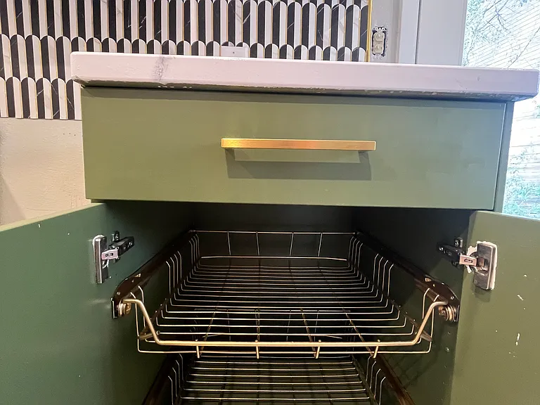 Base cabinet has pull out trays