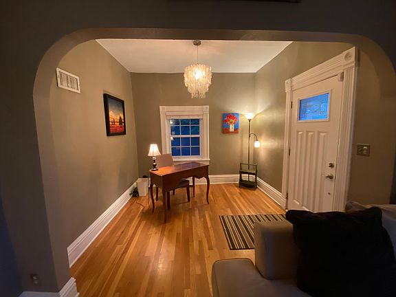 View from living room to front door and entry/office space