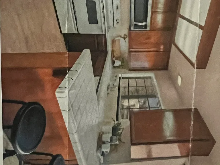 View of kitchen, and bar stool area;
note that the stove and oven are being upgraded to new stainless steel appliance.