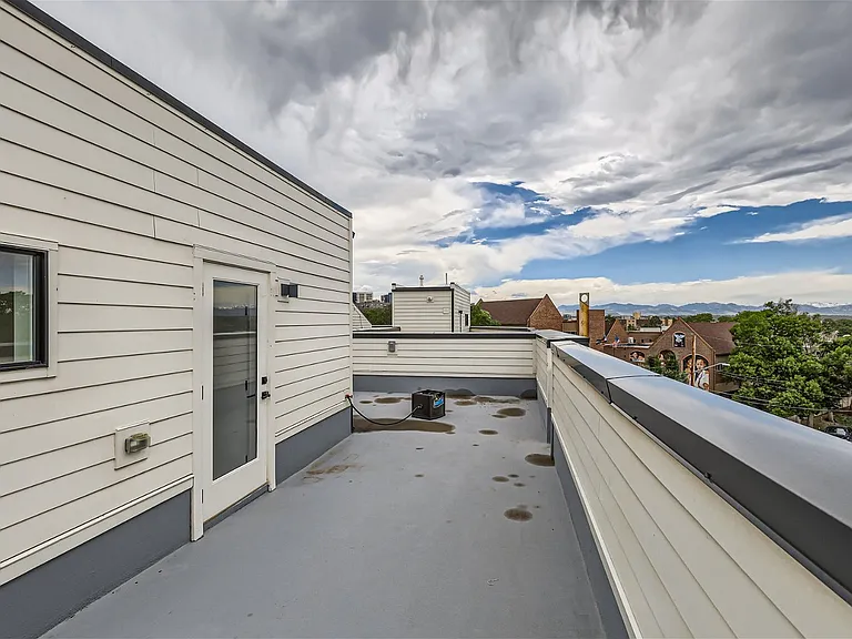 Rooftop patio offers panoramic views of Colorado mountain range and downtown Denver
