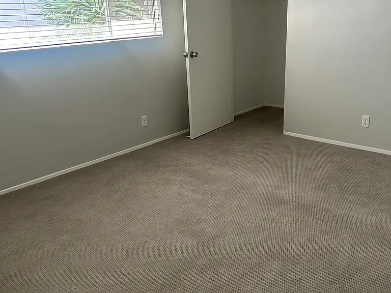 Bedroom with wood blinds