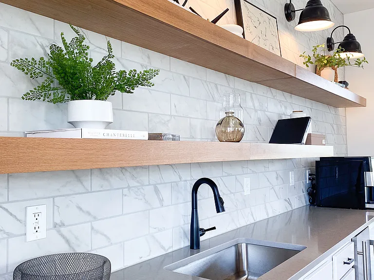 Small touches that make a big difference _ like this backsplash and open shelving setup that brings it all together.