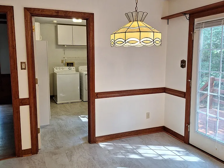 Breakfast area. At left is doorway to Family room, center is doorway to Laundry. Doors to deck on the right.