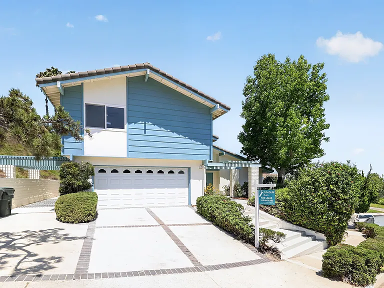 Two car garage with a 3 car wide driveway.