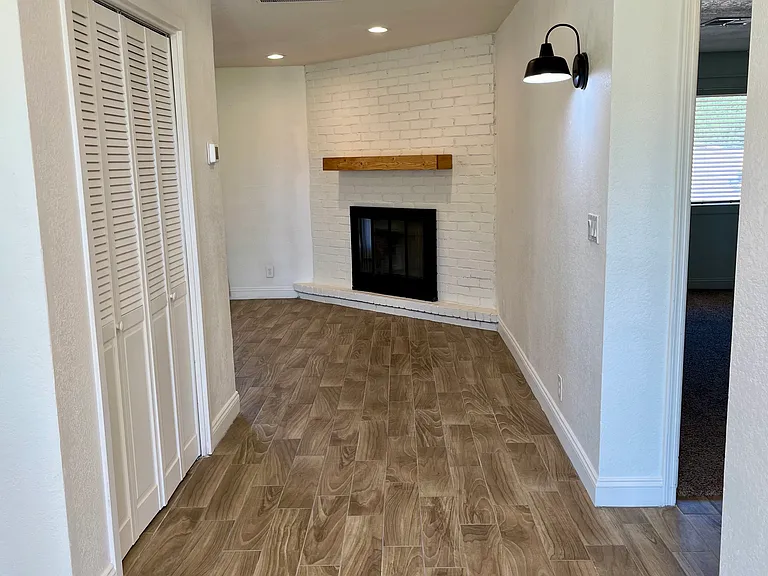 Front Entry Way - very open and bright. Leads to bedrooms, storage closet and wood burning fireplace.