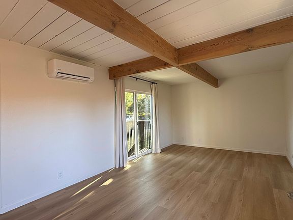 Living room with patio door and split AC