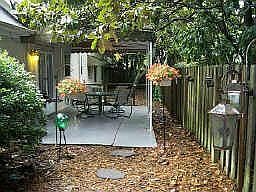 Fully fenced yard with patio and koi pond
