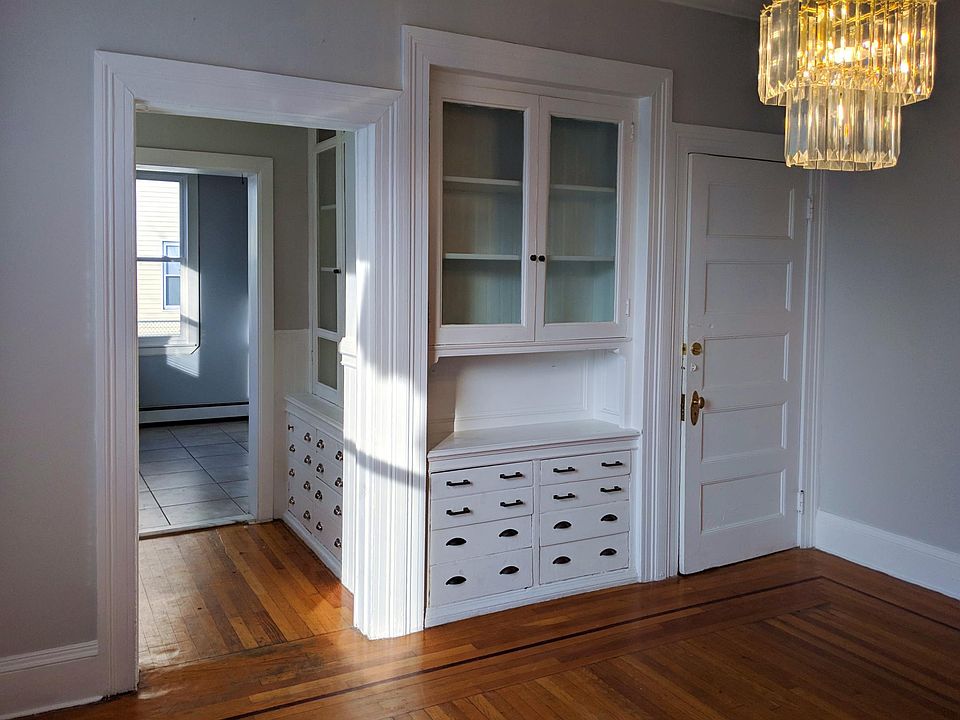 Built in cabinets in the dining room and doors leading to kitchen and back hallway