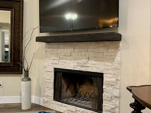 updated fireplace and mantle with room for mounted tv above