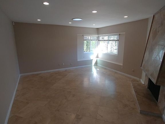 Living room with skylight and recessed lighting