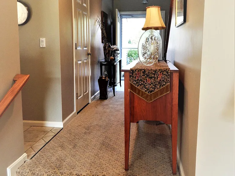 two steps from sunken living room to entrance hallway and kitchen entrance