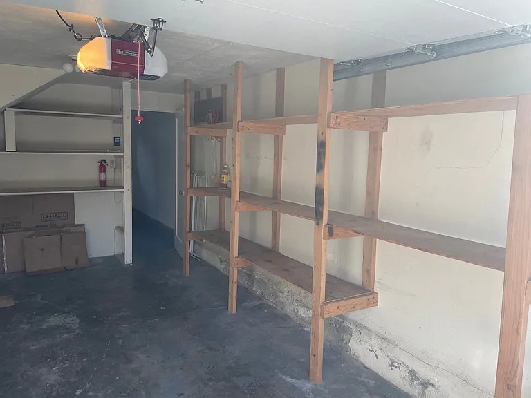 garage with built-in shelving and enough room for a car
