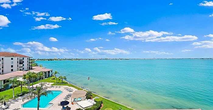 Waterfront balcony with sweeping Boca Ciega Bay views and stunning sunsets