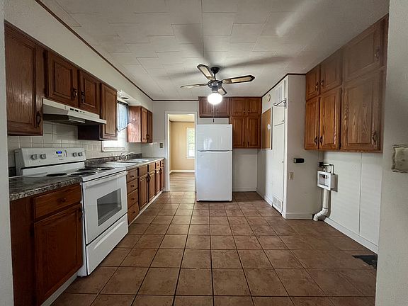 Kitchen with stove and refrigerator provided. Washer and Dryer hook ups are in the kitchen.