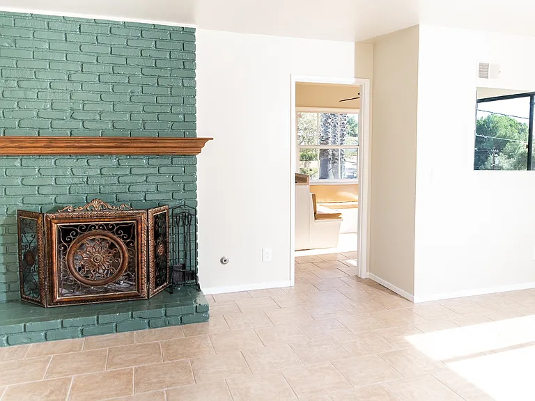Fireplace leading to kitchen