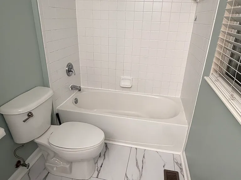 Hallway bath with tub and new LVP flooring.