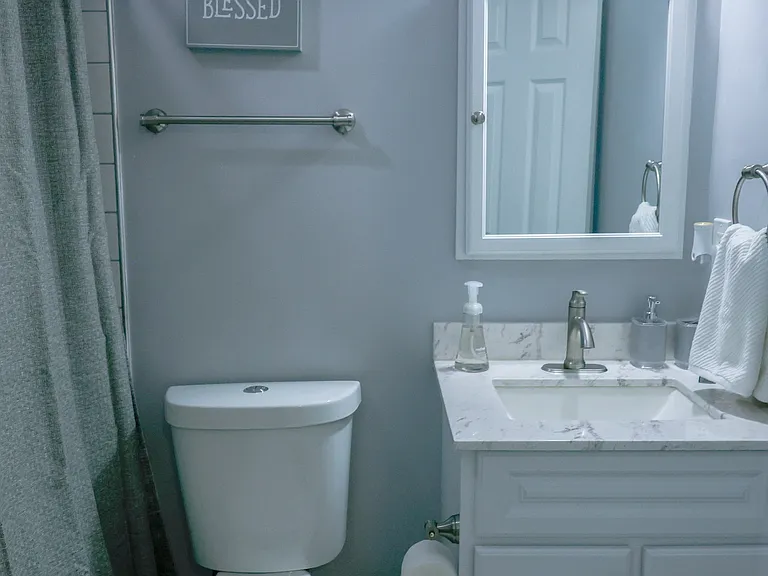 Well-appointed full bathroom featuring a modern vanity, updated lighting, and a clean, bright layout with tub/shower combination.