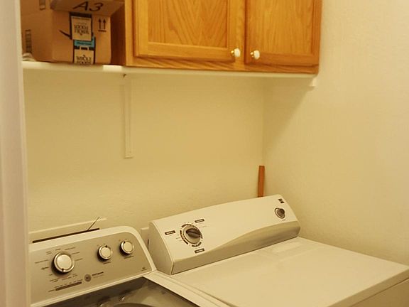 Utility room with pantry along one wall.