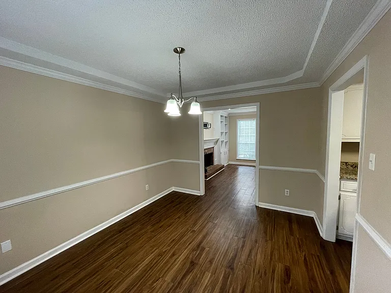 From the kitchen, walk into the dining room which is accessible from both the kitchen and living room