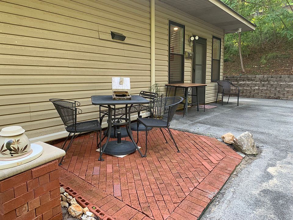 Patio next to the front door. The wrought Iron table will accommodate an umbrella if desired