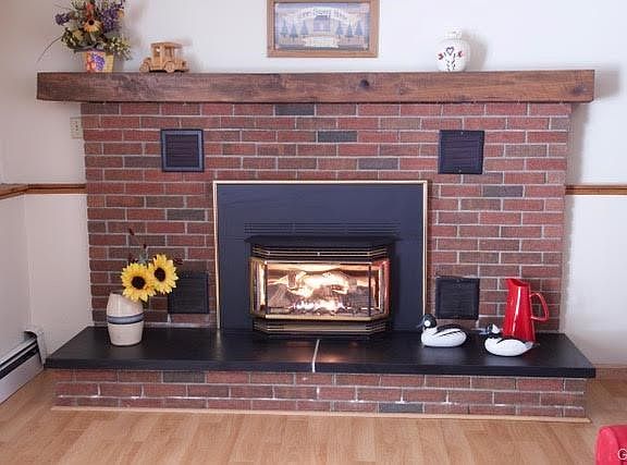 propane fireplace with raised slate hearth also includes the propane tank that is owned by the seller and will be included to the home