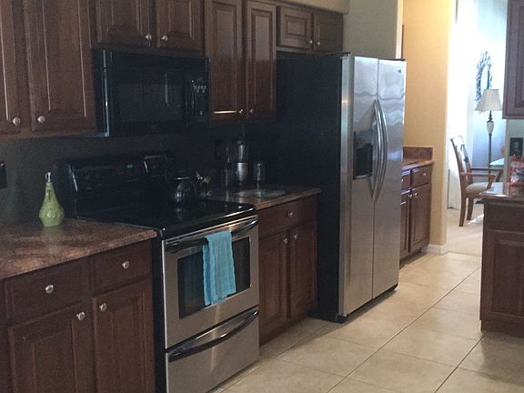 Kitchen with stainless appliances leading to dining room!