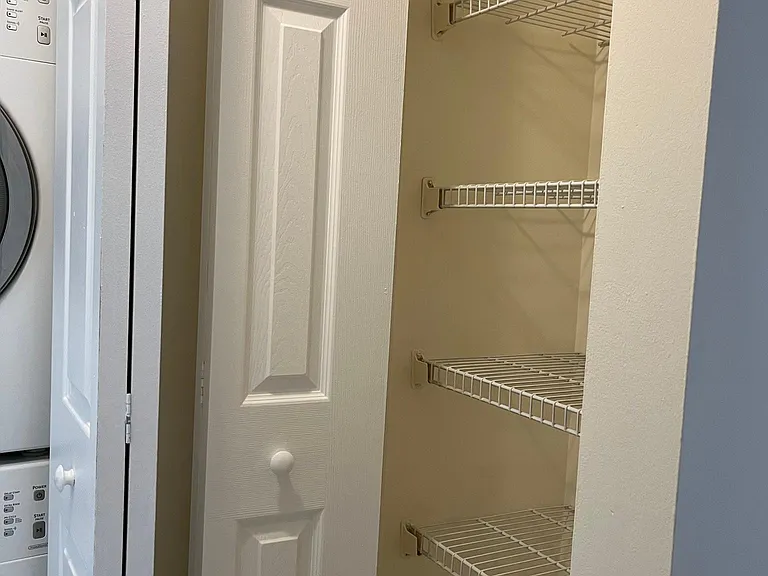 Storage cabinet to the right of the washer and dryer.