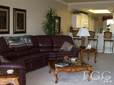 Main living area with crown molding and chair railing.