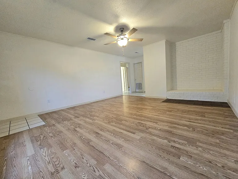 All ceiling fans and lights are brand new, as well as the water heater. All walls have been freshly painted & the brick area on the right is a great place for a TV or bookshelf.