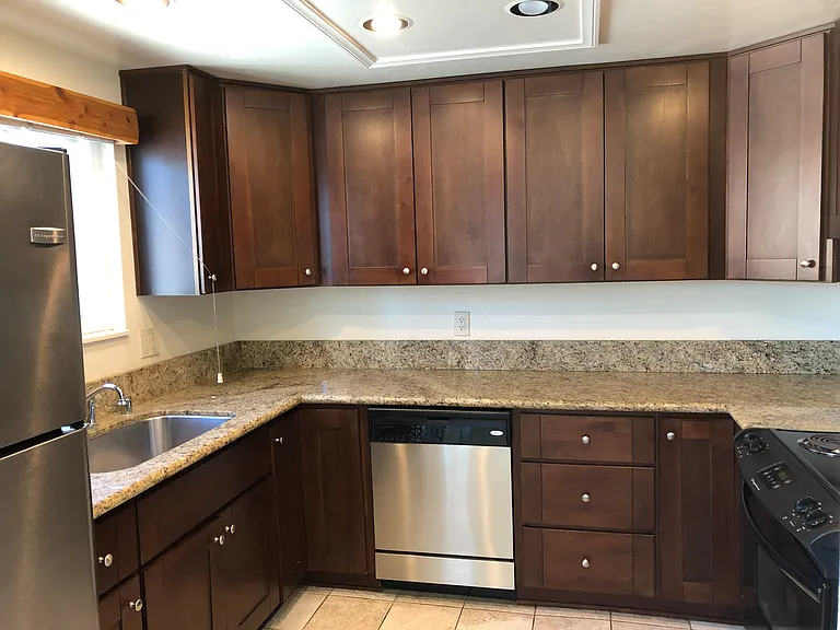 Kitchen showing custom cabinets and granite countertop.