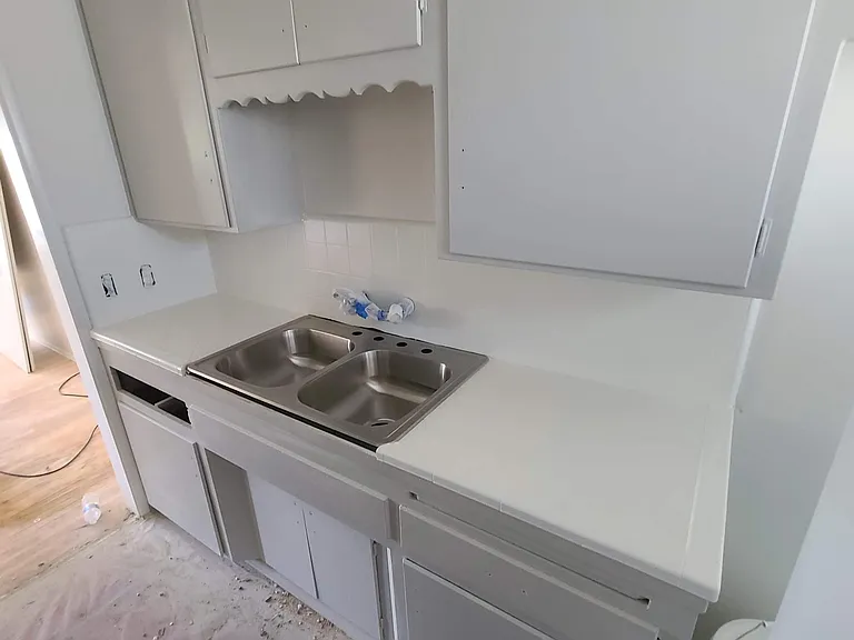 Photo of refinished countertop and cabinets taken during turnover