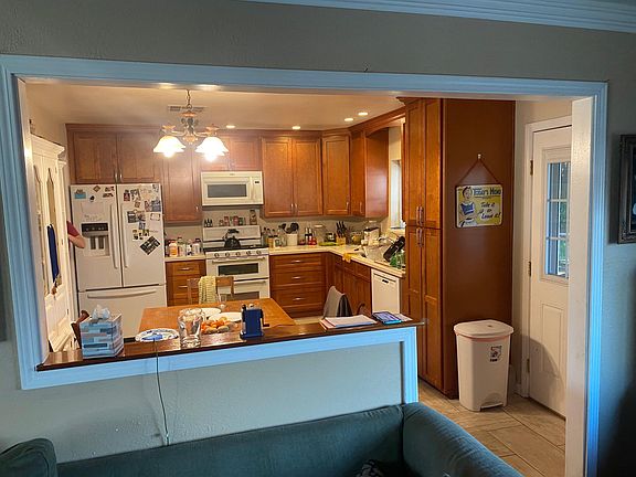 Half wall between living room and kitchen. Microwave and Stove provided.