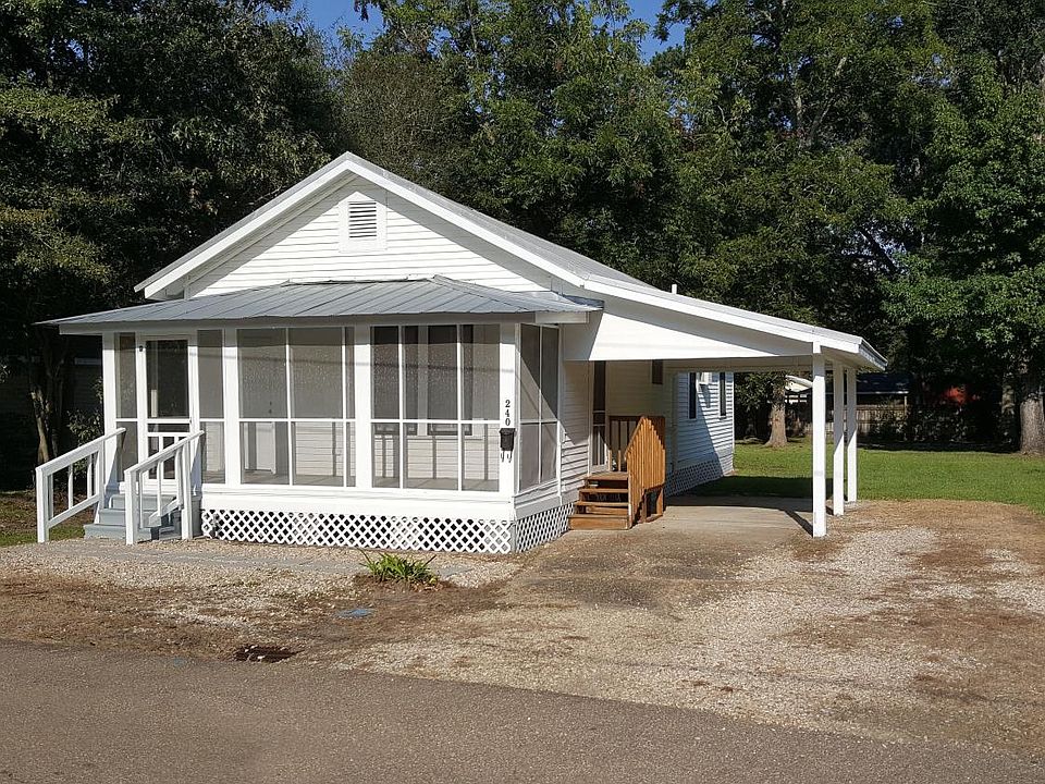 Front of house. Covered carport. Screened in front porch.