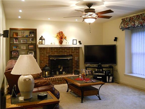 Family room w brick fireplace & recessed lighting