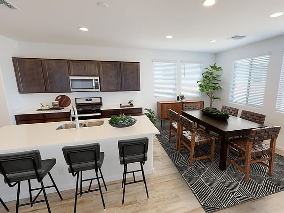 This photo showcases a kitchen with virtually rendered furnishings in a Lantana Plan Home.